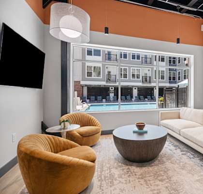 a living room with couches and chairs and a large window