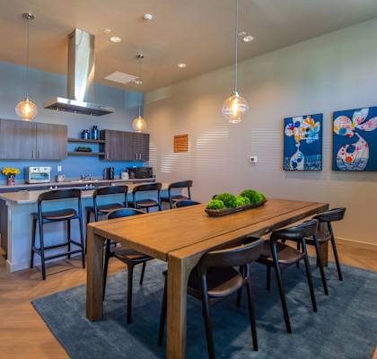 A modern kitchen with a dining table and chairs.