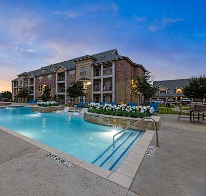 Swimming pool with sundeck at Auberge of Burleson apartments in Burleson TX.
