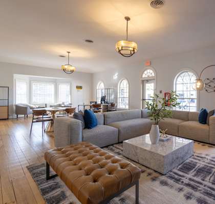 a living room with couches and chairs and a table