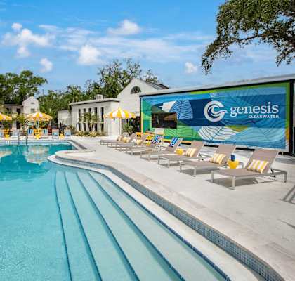 A large swimming pool with a Genesis sign in the background.