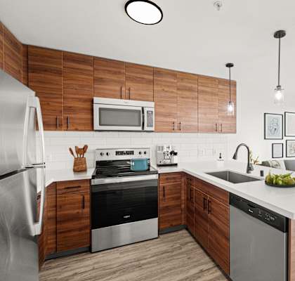 a kitchen with white countertops and wooden cabinets