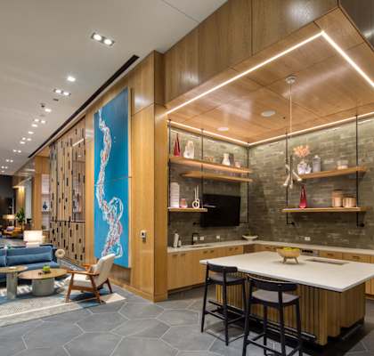the lobby of a hotel with a living room and a table and chairs