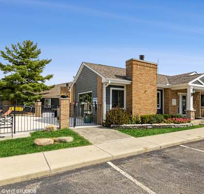 a house with a driveway and a golf cart parked in front of it at Springburne at Polaris Apartments, Columbus, 43235