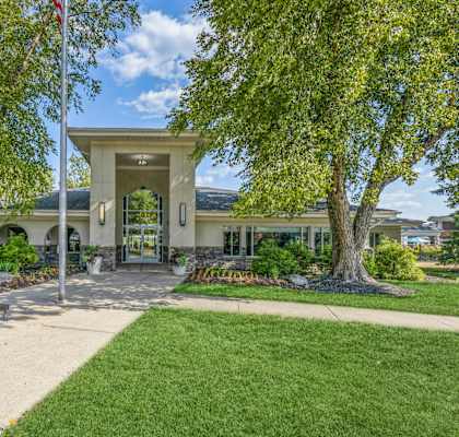 the front of a building with a lawn and trees at Runaway Bay Apartments, Columbus, OH, 43204