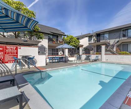 our apartments have a swimming pool and a patio with umbrellas