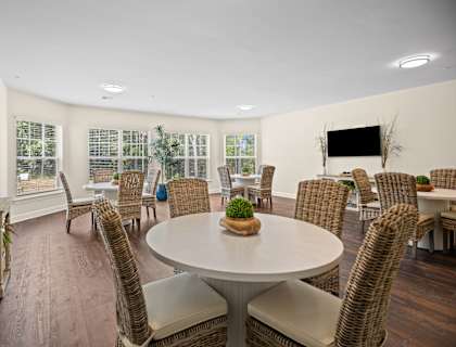 a living room with a table and chairs and a television
