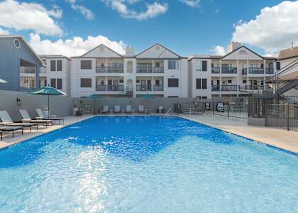 a large swimming pool with a building in the background