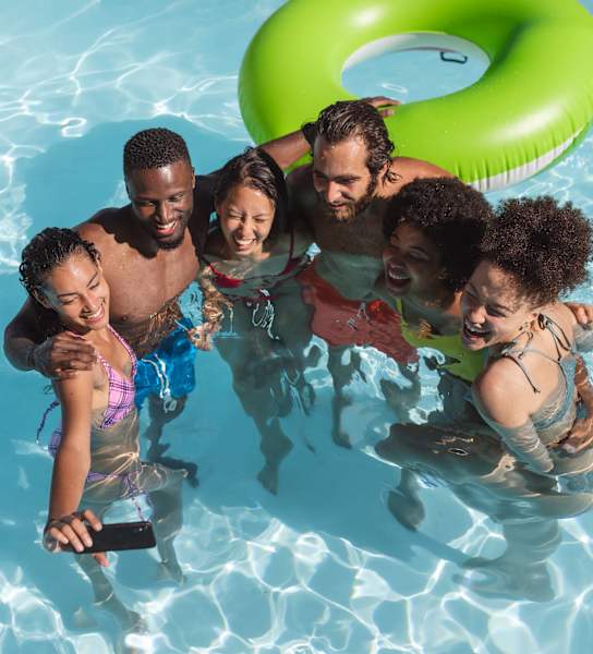 a group of people in a swimming pool with an inflatable tube