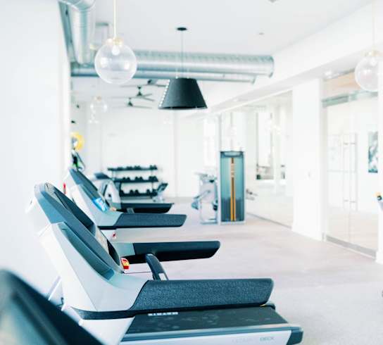 a row of treadmills at the 24-hour fitness center at The Merchant Apartments, Charleston