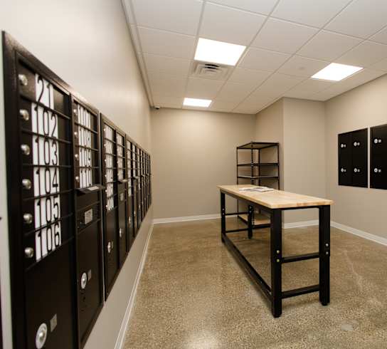 a room with lockers and a table in the middle