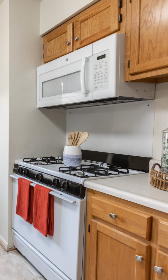 a kitchen with a table and chairs in front of a window at Lawyers Hill Apartments, Elkridge, MD