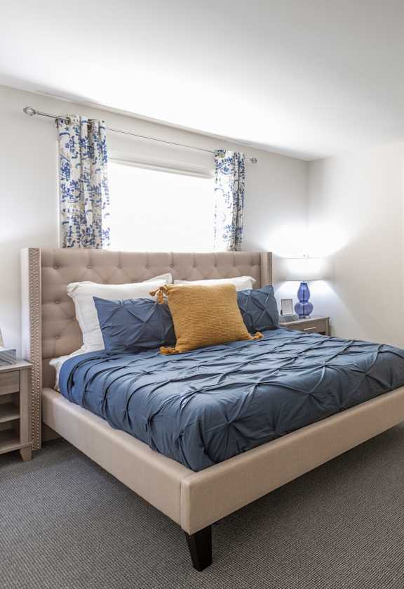 a bedroom with a bed and some paintings on the wall