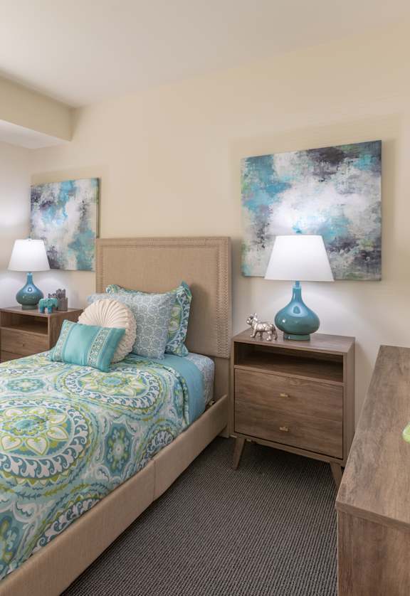 a bedroom with a bed and a dresser and a window