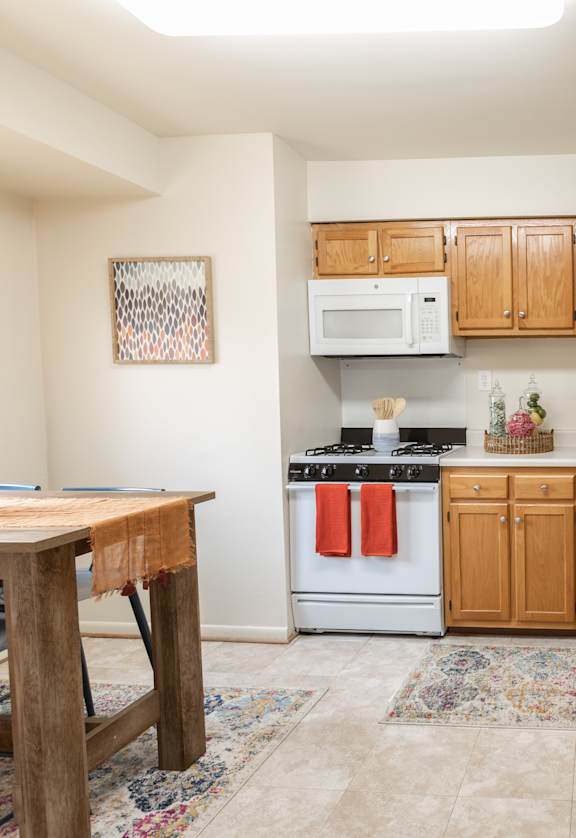a kitchen with white appliances and wooden cabinets