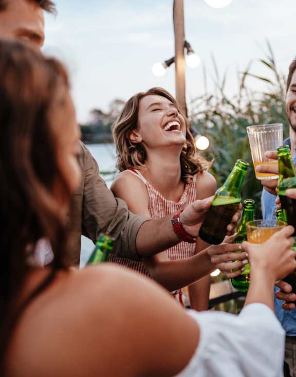 a group of people celebrating with drinks at a party