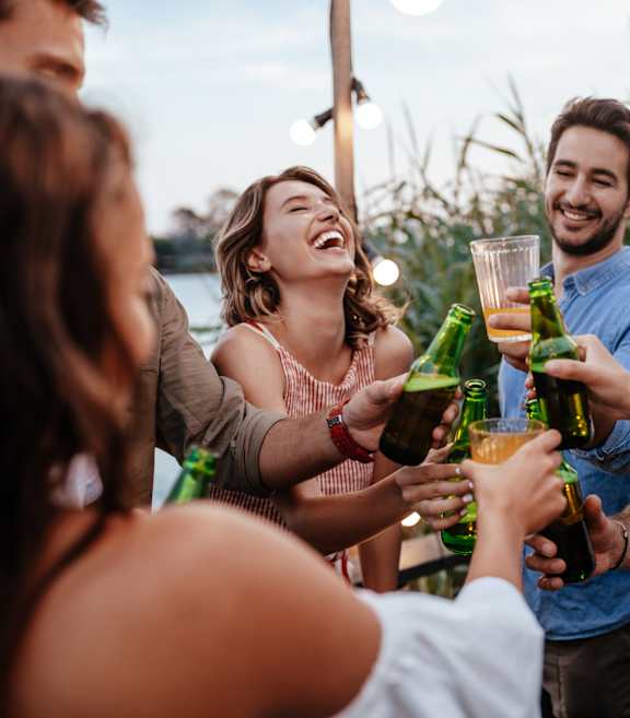 a group of people celebrating with drinks at a party