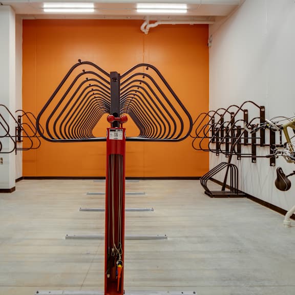 A room with white walls and a white ceiling has a large sculpture in the middle.