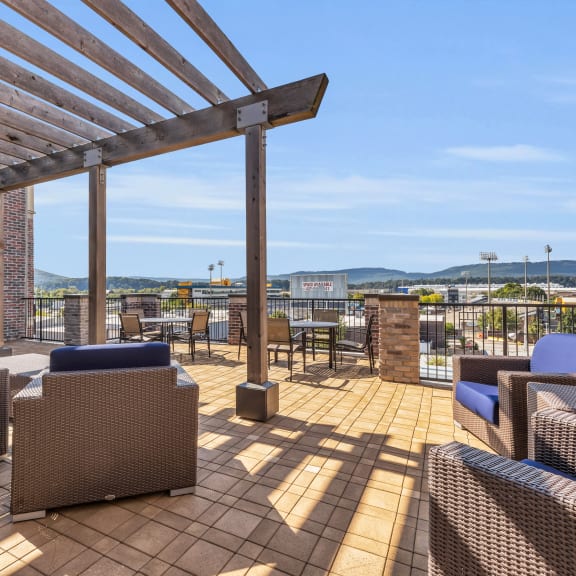 the deck on the roof of a building with furniture and a wooden pergola at 17 Broad, Chattanooga, 37408