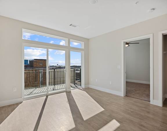 A1 Living space filled with natural light and private balcony overlooking downtown Wilson at Centro at Pine Nash in Wilson, NC