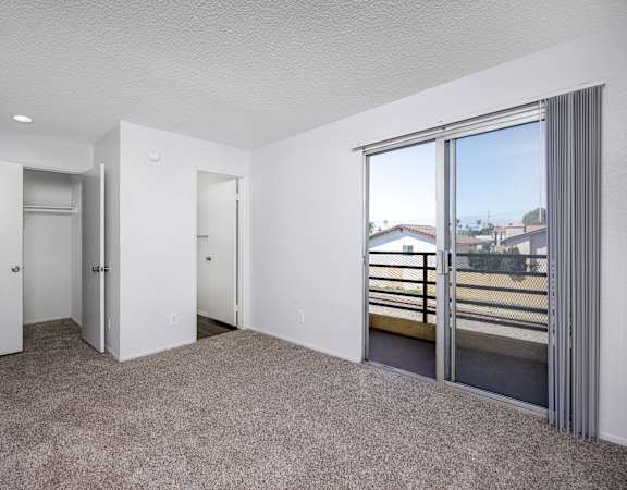 A spacious room with a view of the outside through a large window.