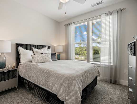 a bedroom with a bed and a large window at Ellis Station, Durham
