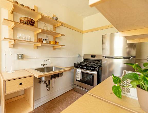 a kitchen with a sink and a stove and a refrigerator