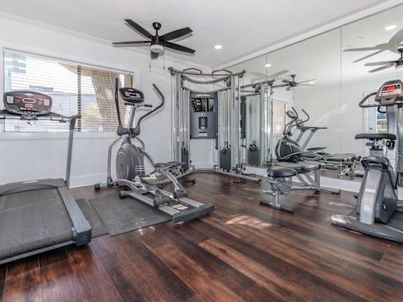 A spacious home gym with a variety of exercise equipment.