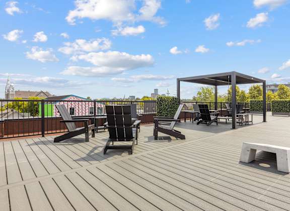 A wooden deck with chairs and a table.