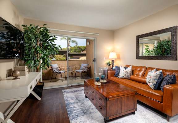 a living room with a brown leather couch and a coffee table