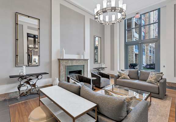 a living room with couches and a table and a fireplace