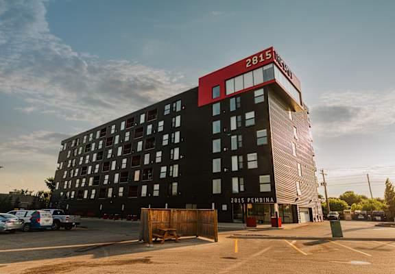 a large building with a red and black top