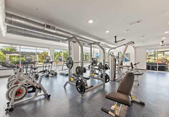 A gym with a variety of equipment including weights and machines.