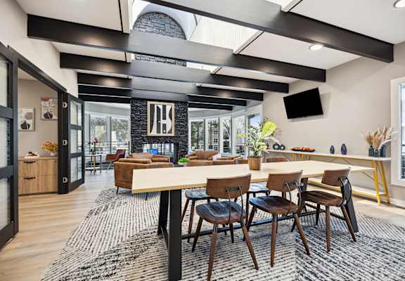 a dining room and living room with a large table and chairs
