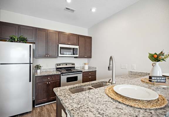 a kitchen with granite counter tops and stainless steel appliances