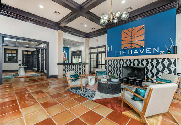 A living room with a fireplace and a sign that says "The Haven.".
