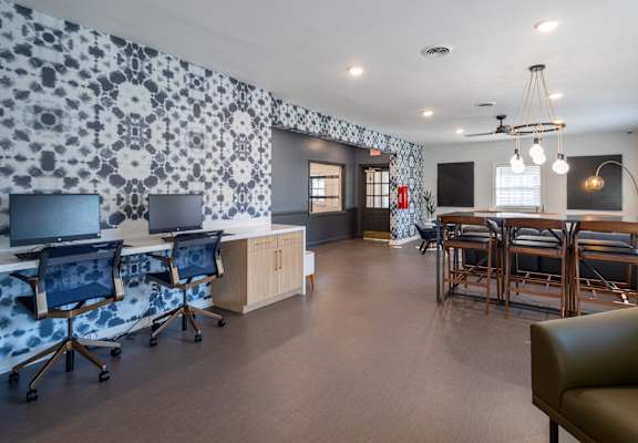 a conference room with desks and chairs and a table with chairs