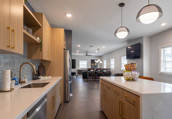 a kitchen with white marble counter tops and wooden cabinets