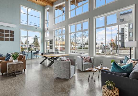a living room with large windows and couches