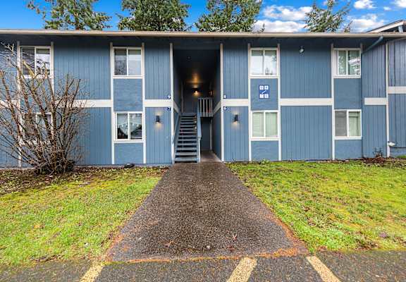A blue building with a white door and windows.