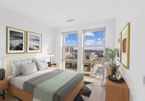 A bedroom with a large bed and a view of the city.