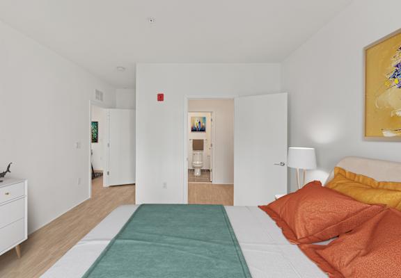 A bedroom with a bed, nightstand, and a painting on the wall.