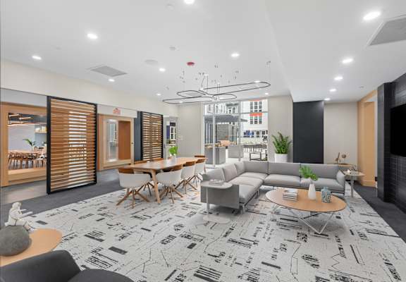 A modern living room with a patterned carpet and a variety of seating options.