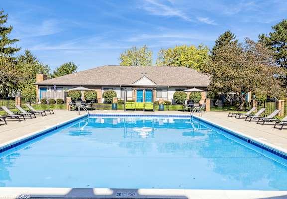 A large swimming pool in front of a house with a blue sky above. at Karric Place of Dublin Apartments, Ohio, 43016