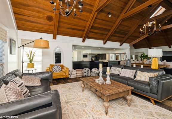 A living room with a wooden ceiling and a large sectional sofa at Island Club Apartments, Columbus, OH