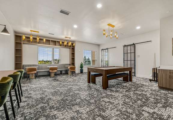 A room with a grey carpet and a wooden table.