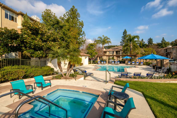 a courtyard with tables and chairs and palm trees