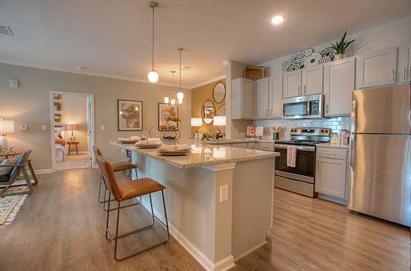 an open kitchen with an island and stainless steel appliances  at Lullwater at Big Ridge, Hixson, TN, 37343