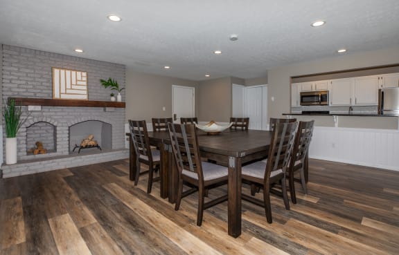 a dining room with a table and chairs in front of a fireplace