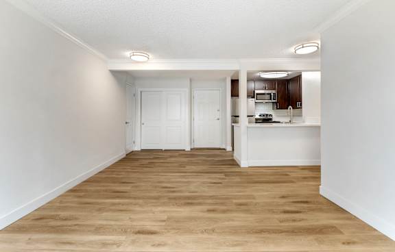 A modern kitchen with a white island and stainless steel appliances.